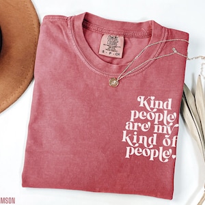 May include: A crimson red t-shirt with the text "Kind people are my kind of people." printed in white.