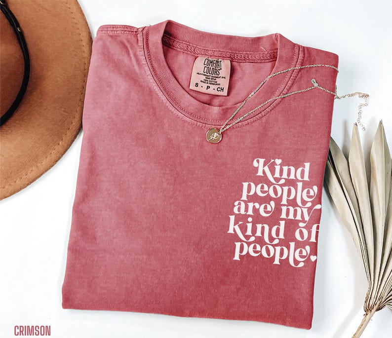 May include: A crimson red t-shirt with the text "Kind people are my kind of people." printed in white.