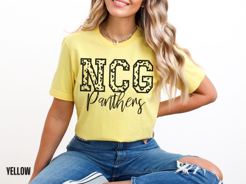 May include: A yellow t-shirt with the text "NCG Panthers" in black. The letters "NCG" have a leopard print design. The word "Panthers" is written in a script font. The word "YELLOW" is at the bottom left.