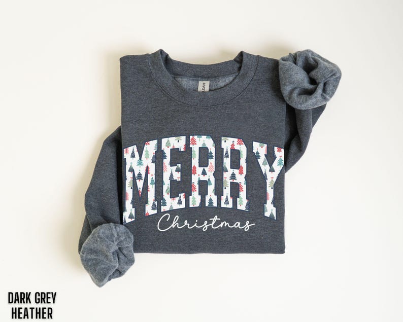 May include: Dark grey heather sweatshirt with a white graphic that says "Merry Christmas" with a pattern of colorful Christmas trees.