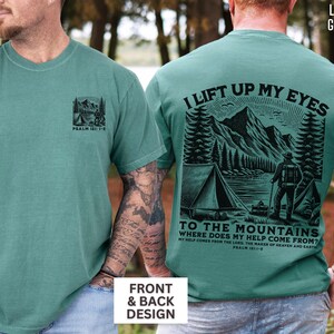 May include: Light green t-shirts with front and back designs. The front features a small mountain and tent graphic with text. The back displays a larger mountain scene with the text "I lift up my eyes to the mountains".