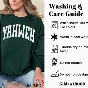 May include: A dark green sweatshirt with the word "YAHWEH" in white, block letters across the chest. The sweatshirt has a crew neck and long sleeves. The image also includes a washing and care guide with instructions and the Gildan 18000 brand.