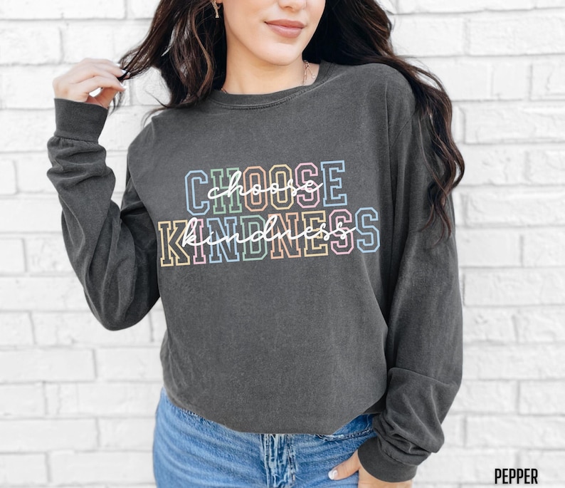 May include: A dark gray long-sleeved shirt with the text "CHOOSE KINDNESS" in rainbow colors.