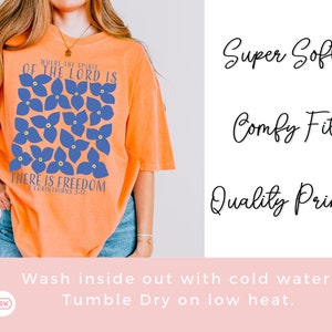 May include: Orange t-shirt with a blue floral design and the text "Where the spirit of the Lord is there is freedom 2 Corinthians 5:17".