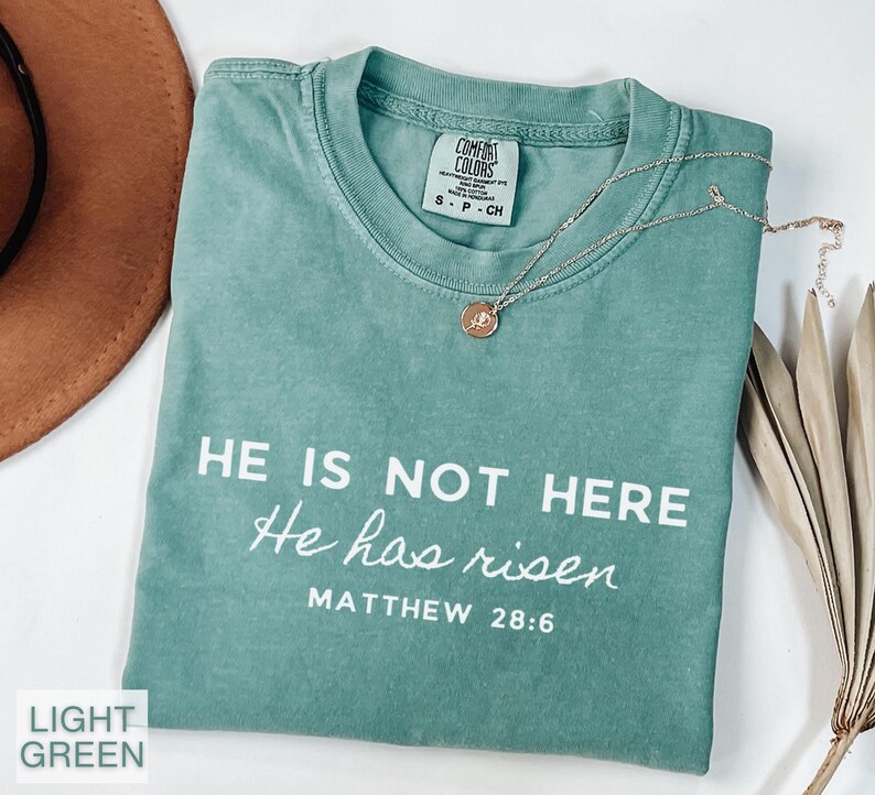This Christian Comfort Colors shirt features the inspiring phrase "He is not here He is risen" for Easter. With a soft and comfortable fit, it's perfect for celebrating the resurrection of Jesus. A great Easter gift for Christian woman.