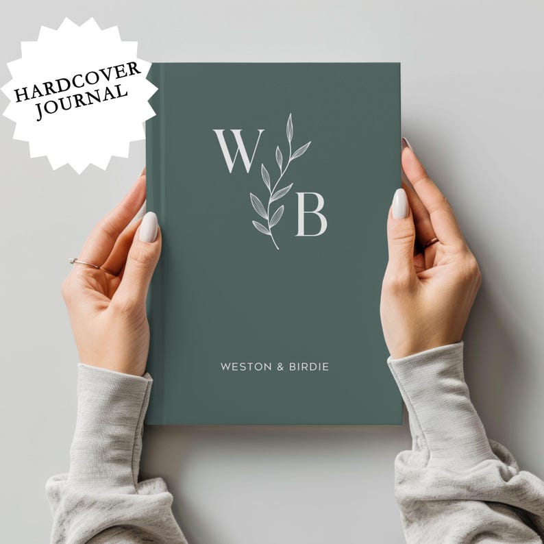 May include: A hardcover journal with a teal green cover featuring a white floral design and the initials "W" and "B" with the text "Weston & Birdie" below.