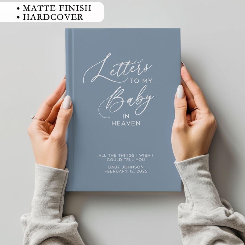 May include: A blue hardcover journal with the text "Letters to my Baby in Heaven" and the words "All the things I wish I could tell you" in white lettering. The journal also includes the name "Baby Johnson" and the date "February 12, 2025".