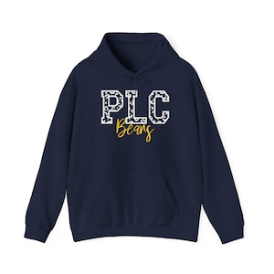 May include: Navy blue hooded sweatshirt with the text "PLC Beans" in white and yellow. The letters "PLC" are in a collegiate style with a pattern, and "Beans" is in a cursive font. The sweatshirt has a front pocket and a drawstring hood.