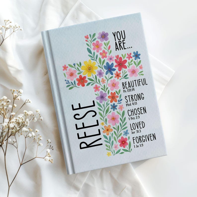 Personalized Christian journal for women and girls with a floral cross design on the cover. The front features “You Are” affirmations with Bible verses and a custom name option. Available in 8 colors, this faith-based notebook can be used for prayer journaling, Bible study notes, gratitude, reflections, and daily writing. Optional customization available for spine and back cover text. Feminine, inspirational gift idea for teens, women, church, or special occasions.