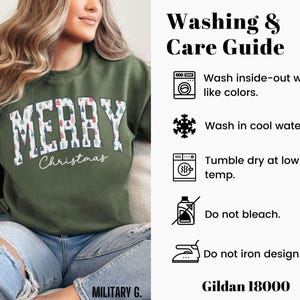 May include: A green sweatshirt with the words "Merry Christmas" printed on the front. The text is surrounded by a pattern of small Christmas trees. The sweatshirt is being worn by a person. The image also includes a washing and care guide for the sweatshirt.