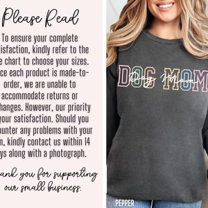May include: A dark gray sweatshirt with the text "DOG MOM" in rainbow colors. The text is in a bold, outlined font.