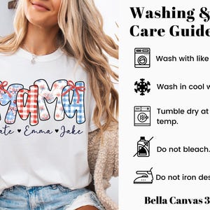 May include: White t-shirt with the word "MAMA" in a patriotic design, featuring red, white, and blue patterns and bows. Below the word "MAMA" are the names "Kate", "Emma", and "Jake". The shirt also includes a washing and care guide.