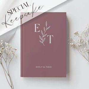 May include: A dusty rose coloured journal with the initials "E" and "T" in white with a small leafy branch design. The text "Emily & Theo" is printed in white at the bottom of the journal.