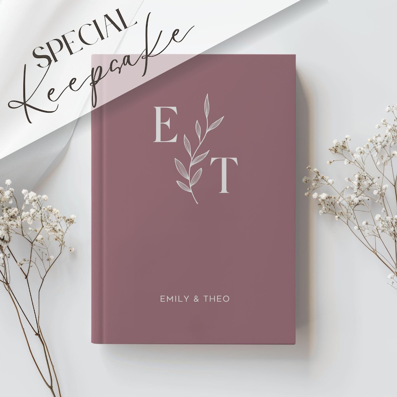 May include: A dusty rose coloured journal with the initials "E" and "T" in white with a small leafy branch design. The text "Emily & Theo" is printed in white at the bottom of the journal.