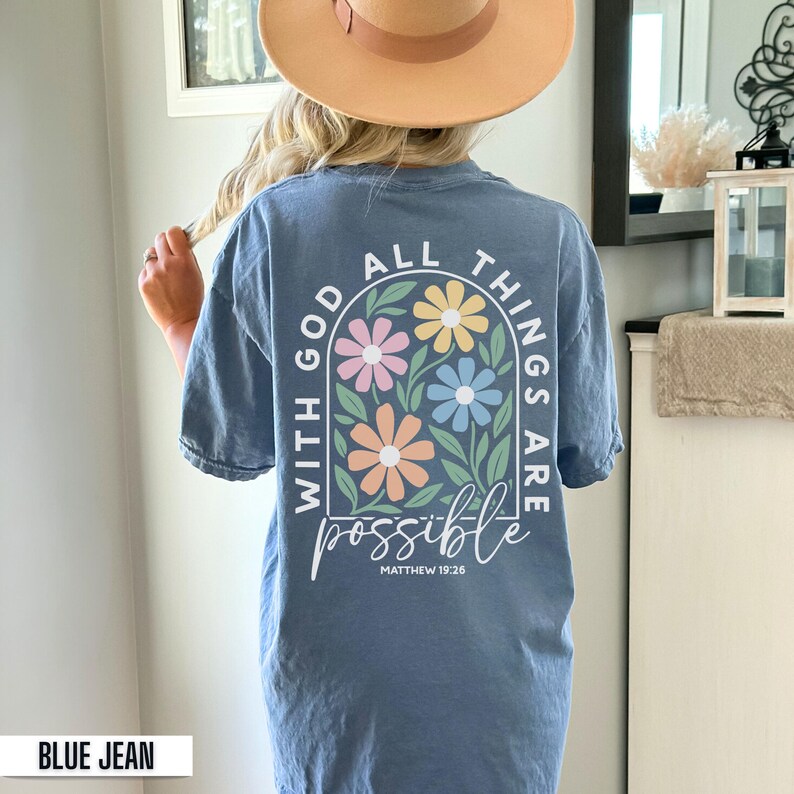 Pastel floral Christian shirt with the phrase With God All Things Are Possible printed on both front and back. Inspirational faith based graphic apparel available in Comfort Colors adult short sleeve t shirts, long sleeve shirts, sweatshirts, and youth short sleeve tees. Soft garment dyed Christian shirt perfect for church, Bible study, everyday faith wear, and Christian gifts.