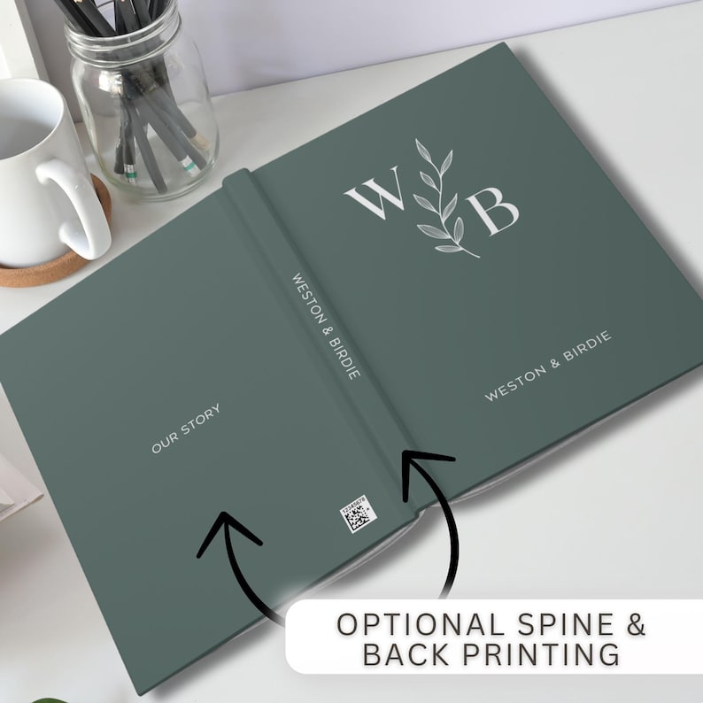 May include: A green hardback journal with the text "OUR STORY" on the front cover and "WESTON & BIRDIE" on the spine. The back cover features a white floral design with the initials "W" and "B".
