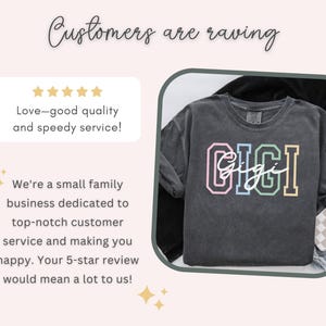 May include: A black t-shirt with the word "GIGI" printed in rainbow colors. The word "Gigi" is written in cursive underneath the larger letters. The t-shirt is on a white and black checkered background.