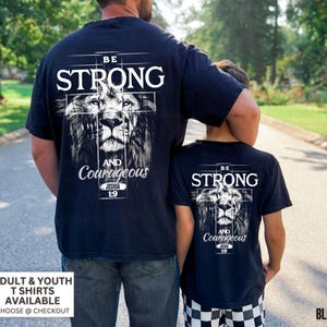 May include: Black t-shirts with a lion graphic and the words "BE STRONG AND Courageous" and "Joshua 1:9". The shirts are available in adult and youth sizes. The word "BLACK" is in the bottom right corner.