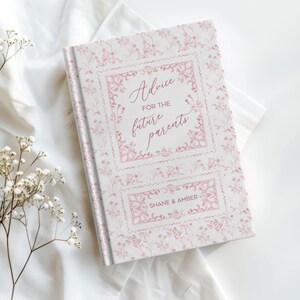 May include: A hardcover book with a floral pattern and the text "Advice for the future parents" in pink script. The book's cover is white with pink floral accents and the names "Shane & Amber" are printed at the bottom.