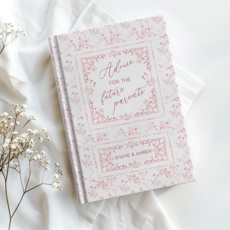 May include: A hardcover book with a floral pattern and the text "Advice for the future parents" in pink script. The book's cover is white with pink floral accents and the names "Shane & Amber" are printed at the bottom.