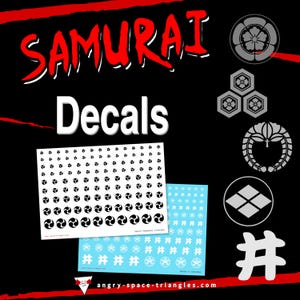 May include: Black background with the word "SAMURAI" in red and white, and the word "Decals" in white. Two sheets of decals are shown, one white and one light blue, with various Japanese symbols. Several Japanese crests are also displayed.