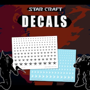 May include: A set of Star Craft decals featuring two sheets of small adhesive transfers. One sheet displays black symbols in varying sizes, while the other contains white symbols. The text "STAR CRAFT" and "DECALS" appears at the top of the image.