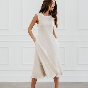 White modern sleeveless dress, form fitting shape with pockets for timeless and modern office look in midi length image 2