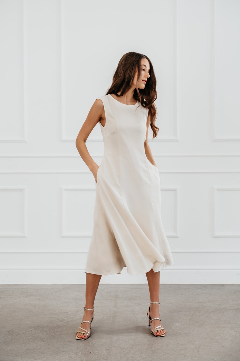 White modern sleeveless dress, form fitting shape with pockets for timeless and modern office look in midi length image 2