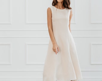 White modern sleeveless dress, form fitting shape with pockets for timeless and modern office look in midi length