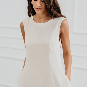 White modern sleeveless dress, form fitting shape with pockets for timeless and modern office look in midi length image 5