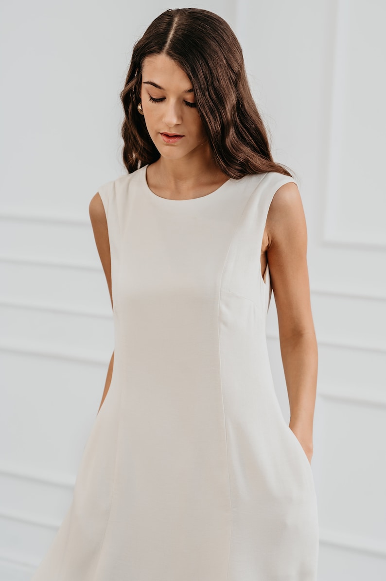 White modern sleeveless dress, form fitting shape with pockets for timeless and modern office look in midi length image 5