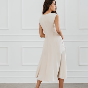 White modern sleeveless dress, form fitting shape with pockets for timeless and modern office look in midi length image 3