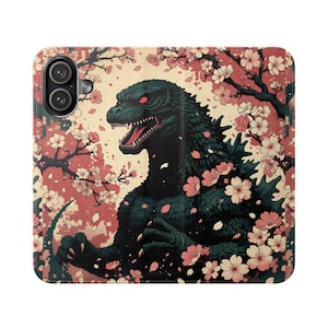 May include: A phone case featuring a Godzilla illustration with cherry blossoms. The design showcases a dark green Godzilla with red eyes, set against a backdrop of pink and white flowers and branches. The case has a camera cutout.
