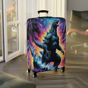 May include: A black suitcase with a colourful print of a Godzilla-like monster in a fiery, neon-coloured background. The suitcase has wheels and a handle.
