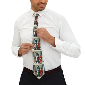 May include: A silk tie with a repeating pattern of Santa Claus and a Godzilla-like creature. The tie is green, red, white, and blue.
