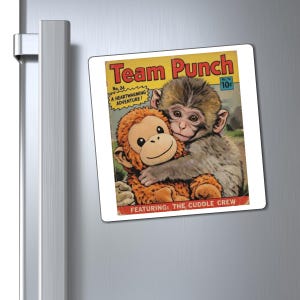 May include: A square magnet featuring a vintage comic book cover design. The cover art depicts a monkey hugging a stuffed monkey. Text includes "Team Punch," "A Heartwarming Adventure!" and "Featuring: The Cuddle Crew."