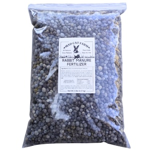May include: A 5-pound bag of rabbit manure fertilizer from Mad Cat Farm. The fertilizer is all-natural, slow-release, plant-safe, and easy-to-use. The bag is filled with small, dark brown pellets.