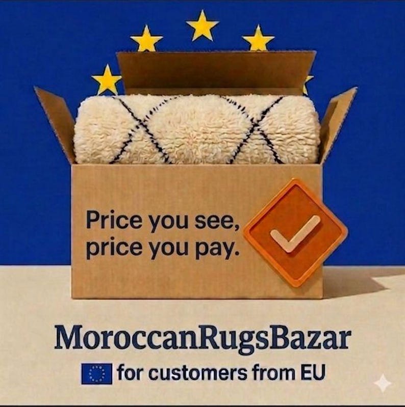 May include: A rolled, cream-colored rug with a black diamond pattern inside a cardboard box. The box has the text "Price you see, price you pay." The logo for Moroccan Rugs Bazaar is below the box.