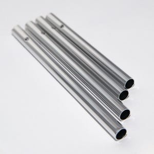 May include: Five silver metal tubes of varying lengths, stacked on top of each other. The tubes are smooth and shiny, with a slight curve at the end.