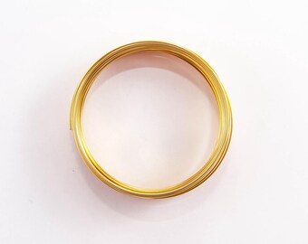 May include: A coil of gold-colored wire, perfect for crafting jewelry or other projects.