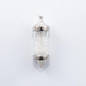 May include: A silver-toned pendant with a clear glass vial filled with small, white crystals. The vial is capped with silver metal at both ends and has a loop for a chain. The pendant is set against a white background.