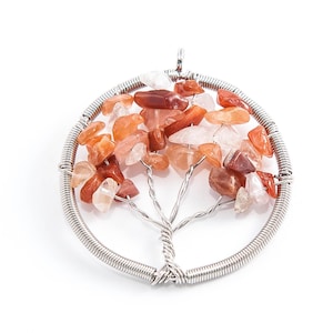May include: A silver wire tree of life pendant with carnelian and clear quartz stones.