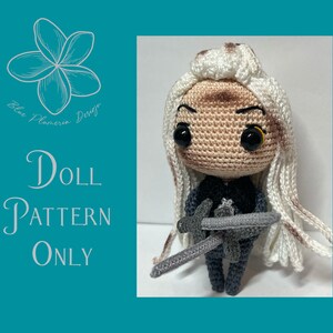 May include: Crochet doll pattern for a character with long white hair, wearing a black outfit and holding a sword. The pattern is available for purchase. "Doll Pattern Only" is written on the image.