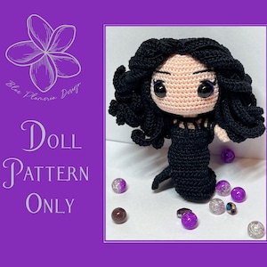 May include: Crochet doll pattern for a black-haired doll wearing a black dress. The doll has large eyes and a sweet expression. The pattern is available for purchase.  "Doll Pattern Only" is written on the image.