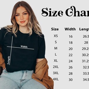 May include: A black t-shirt with a size chart, featuring measurements for width and length in inches. The chart includes sizes XS to 4XL. The text "Size Chart" is displayed in a decorative font.