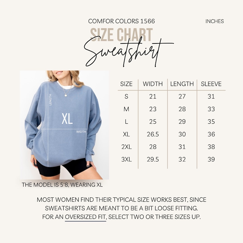 Puede incluir: Una sudadera azul claro con una etiqueta de talla XL, mostrada con una tabla de tallas. La tabla enumera las tallas S a 3XL, con medidas en pulgadas para el ancho, largo y manga. El texto dice "COMFOR COLORS 1566" y "Sweatshirt".