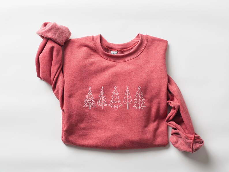 May include: A red sweatshirt with a white outline of five Christmas trees on the front.