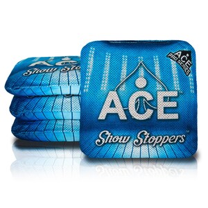May include: Four blue and white cornhole bags with the text "ACE Show Stoppers" and "ACE Pro Series" printed on them.