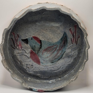 Vintage, handmade, art pottery dish with a beautiful bird design.