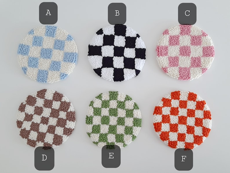 May include: Six round, crocheted checkerboard coasters in various colors, including blue, black, pink, brown, green, and orange. The coasters are labeled A through F.